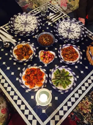 a table with many plates of food on it at Riad Lalla Fatima in Fès
