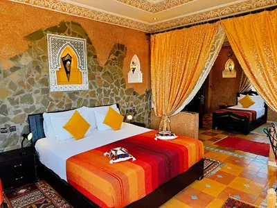 a bedroom with a large bed in a room at Riad Chay & Boutique in Ouarzazate