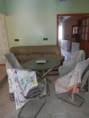 a living room with a couch and a table and chairs at Oasispalmares in Er Rachidia