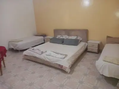 a room with three beds in a room at Oasispalmares in Er Rachidia