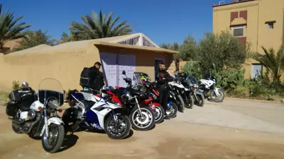 a row of motorcycles parked in front of a building at Oasispalmares in Er Rachidia