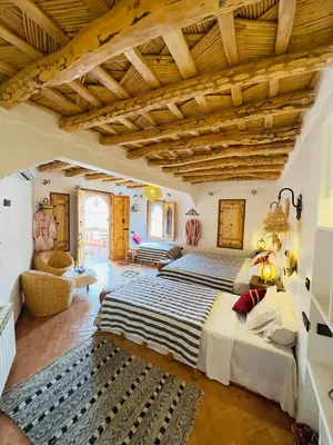 a bedroom with a large bed in a room at Dar Ahlam Dades Hotel in Aït Ouaddar