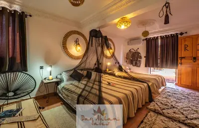 a bedroom with a bed with a net on it at Dar Ahlam Dades Hotel in Aït Ouaddar
