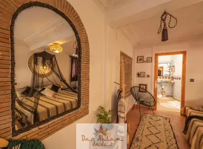 a room with a mirror with a bed in it at Dar Ahlam Dades Hotel in Aït Ouaddar