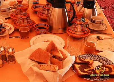 a table with a bunch of slices of bread on it at Luxury Sahara Dream Camp in Merzouga