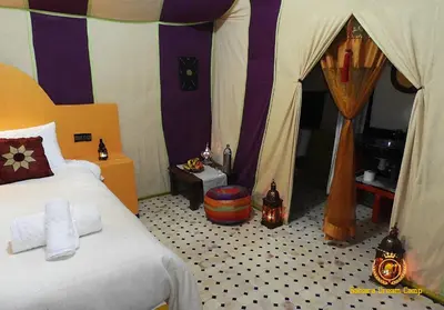 a bedroom with a bed and a tent at Luxury Sahara Dream Camp in Merzouga
