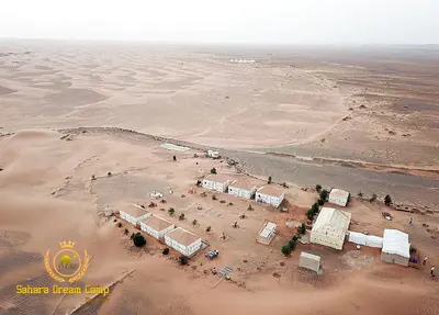 an aerial view of a desert with a group of buildings at Luxury Sahara Dream Camp in Merzouga