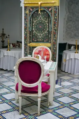 a room with two chairs and a table at Riad Maison Bleue and Spa in Fès