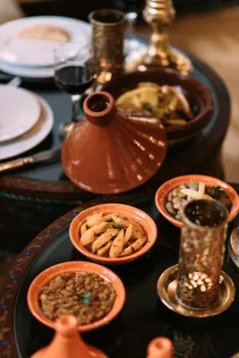 a table topped with plates and bowls of food at Riad Maison Bleue and Spa in Fès