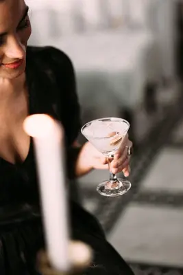a woman holding a martini in a glass at Riad Maison Bleue and Spa in Fès