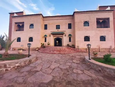 a large brick building with a courtyard in front at Kasbah Zitoune in Ouarzazate