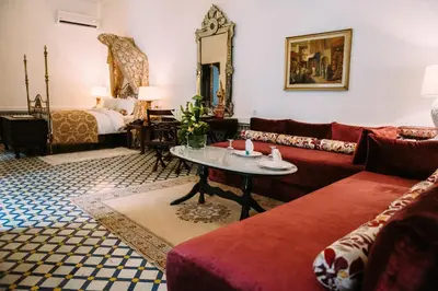 a living room with a couch and a bed at La Maison Bleue Batha in Fès