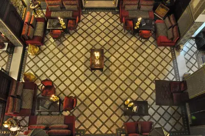 an overhead view of a waiting room with chairs and candles at La Maison Bleue Batha in Fès