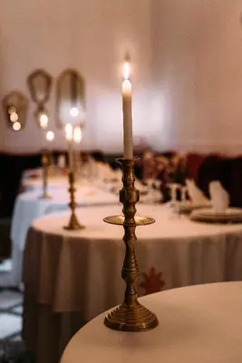 two candles sitting on tables in a room at La Maison Bleue Batha in Fès