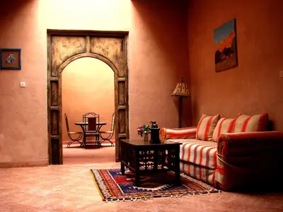 a living room with a couch and an open door at Dar Bilal in Aït Ben Haddou