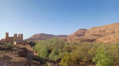 a view of the desert with a castle in the distance at Dar Bilal in Aït Ben Haddou