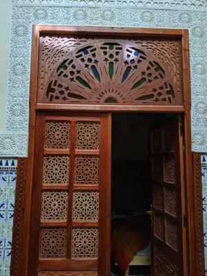 a wooden door with a patterned design on it at Dar nadaa in Fès