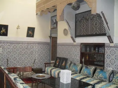a living room with a couch and a table at Dar nadaa in Fès