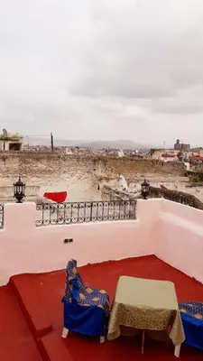 a patio with two chairs and a table and a view at Dar nadaa in Fès