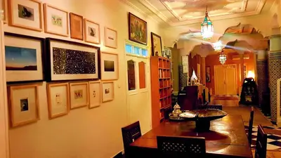 a dining room with a table and pictures on the wall at Riad Dar Sofian in Zagora
