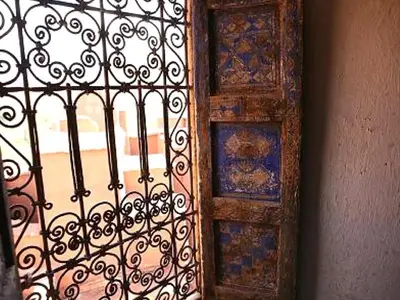 an iron gate with a window in a room at Kasbah Tigmi N'Oufella in Telouet