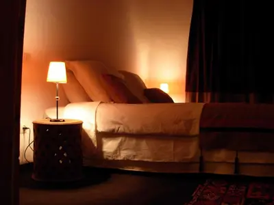 a bedroom with a bed with a lamp on it at Kasbah Tigmi N'Oufella in Telouet