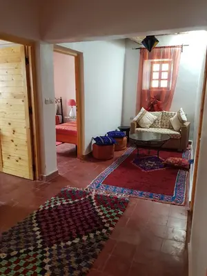 a living room with a couch and a rug at Chez Laila in Skoura
