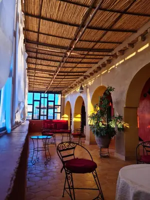 a room with chairs and tables in a building at Chez Laila in Skoura