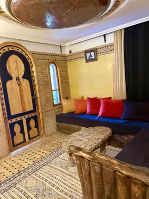 a train room with a couch and a table at Dar Rihana Dadès in Aït Idaïr