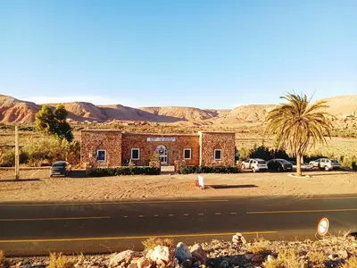 a brick building on the side of a road at Kasbah Imini Restaurant & Hotel in Taourirt