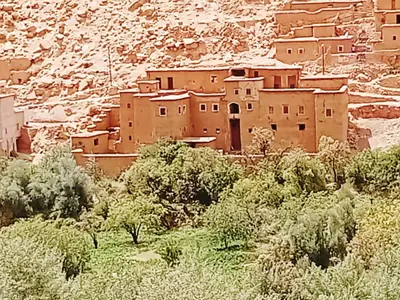 a village in the middle of a mountain at Kasbah Imini Restaurant & Hotel in Taourirt