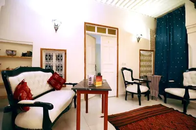 a living room with a couch and a table and chairs at Dar Zerhoune in Moulay Idriss Zerhoun