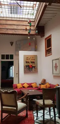 a living room with a table and a couch at Dar Zerhoune in Moulay Idriss Zerhoun