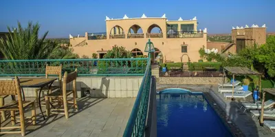 a house with a swimming pool and a building at Taloute Ecolodge in Skoura