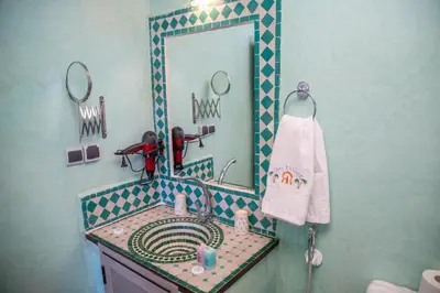 a bathroom with a sink and a mirror at Taloute Ecolodge in Skoura