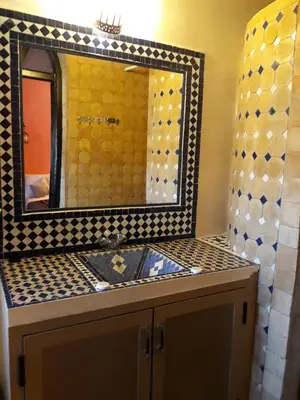 a bathroom with a sink and a mirror at Taloute Ecolodge in Skoura