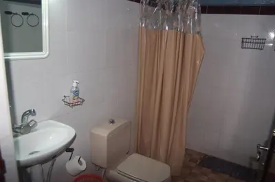 a bathroom with a toilet and a sink and a shower at Haven La Chance Desert Hotel in Merzouga