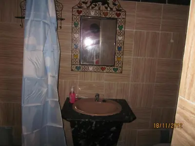 a bathroom with a sink and a mirror at Haven La Chance Desert Hotel in Merzouga