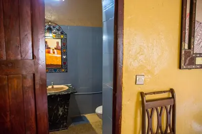 a bathroom with a sink and a toilet and a mirror at Haven La Chance Desert Hotel in Merzouga