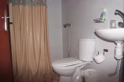 a bathroom with a toilet and a sink at Haven La Chance Desert Hotel in Merzouga