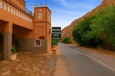 an empty street next to a building with a sign at Riad pizzeria Marhaba in Akhendachou nʼAït Ouffi