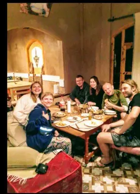 a group of people sitting around a table eating at Riad pizzeria Marhaba in Akhendachou nʼAït Ouffi