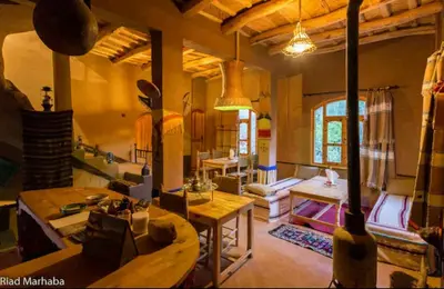 a living room with a couch and a table at Riad pizzeria Marhaba in Akhendachou nʼAït Ouffi