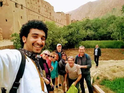 a group of people standing in front of a castle at Riad pizzeria Marhaba in Akhendachou nʼAït Ouffi