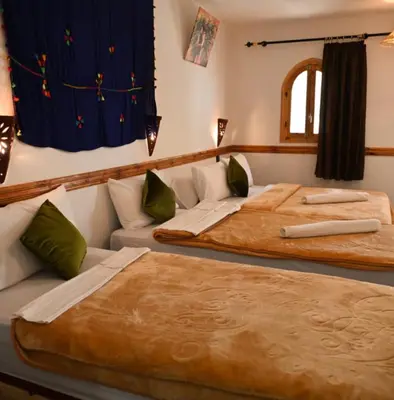 two beds sitting next to each other in a room at Riad pizzeria Marhaba in Akhendachou nʼAït Ouffi