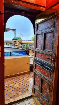 an open door with a view of a building at Dar La Bague de Kenza in Fès
