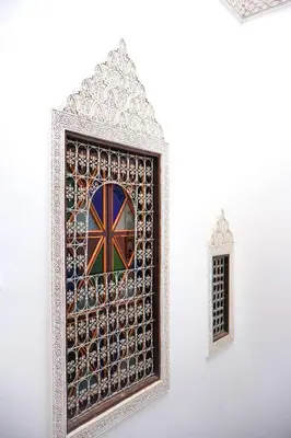a mosaic window with the british flag on it at Riad Mounana fez 13th century luxury palace& spa in Fès
