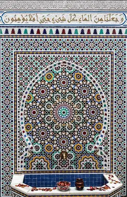 a tiled wall with a mosaic pattern on it at Riad Mounana fez 13th century luxury palace& spa in Fès