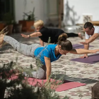 a group of people doing yoga on mats at Riad Mounana fez 13th century luxury palace& spa in Fès
