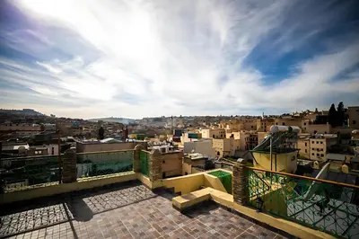 a view of a city from the roof of a building at Riad Mounana fez 13th century luxury palace& spa in Fès
